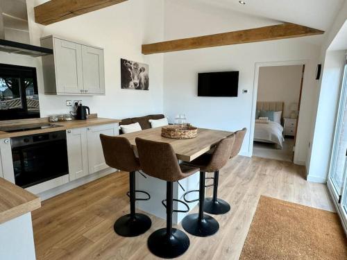 a kitchen with a table and chairs in a room at Countryside Apartment in Trowbridge