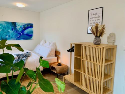 a bedroom with a bed and a plant at Lilly o Wellness o Hideaway in Ingenbohl