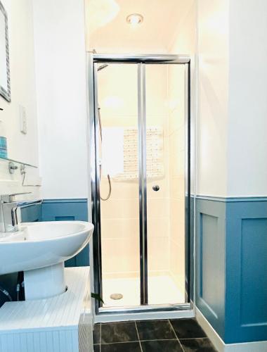 a bathroom with a shower and a sink at River house in Birnam