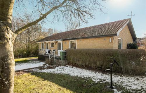 a house with a fence in front of it at Lovely Home In Gudhjem With Wifi in Gudhjem