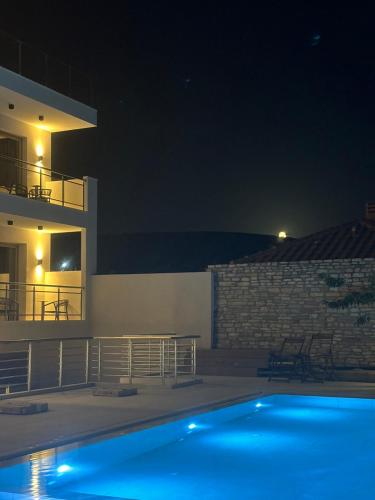 a swimming pool in front of a house at night at Calma Living in Potos