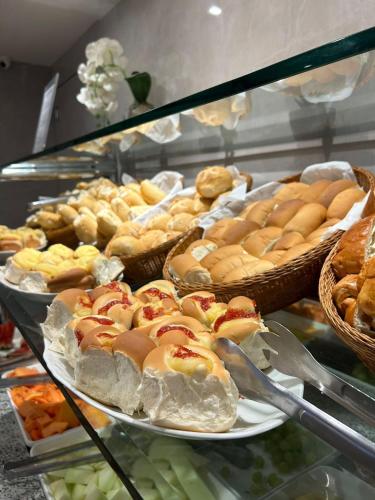a display case with many different types of pastries at Residencial Sausalito in Rio de Janeiro