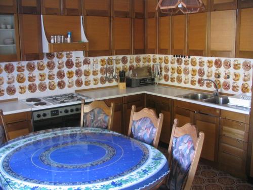 a kitchen with a table with chairs and a sink at Apartment Milan in Zreče