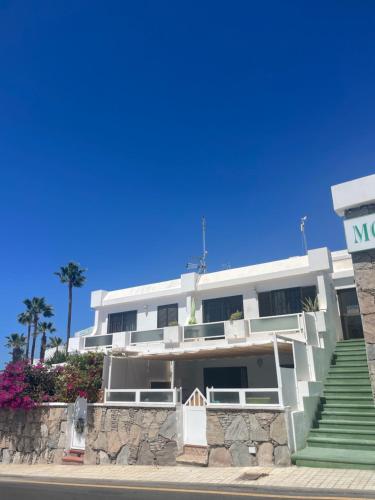 a white building on the side of a street at San Miguel Apartment Amadores Beach in Puerto Rico de Gran Canaria