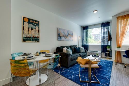 a living room with a couch and a table at Bright & Cozy Walkable Alberta Condo, Fast WiFi, & Quite in Portland