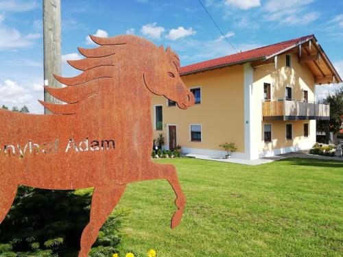 a horse statue in front of a house at Ponyhof Adam Urlaub auf dem Bauernhof in Eschlkam