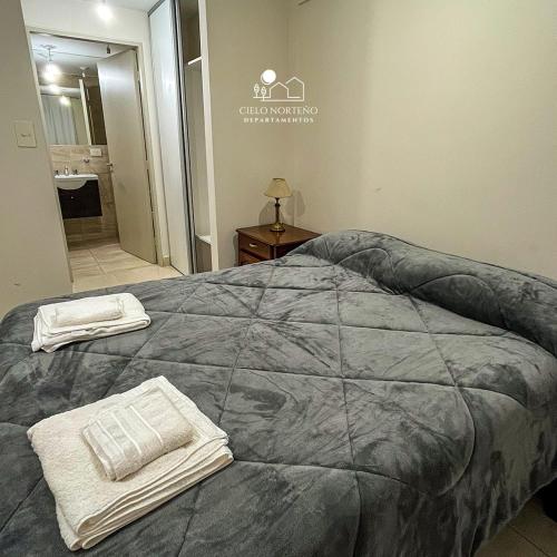 a bedroom with a bed with two towels on it at Cielo Norteño in San Salvador de Jujuy