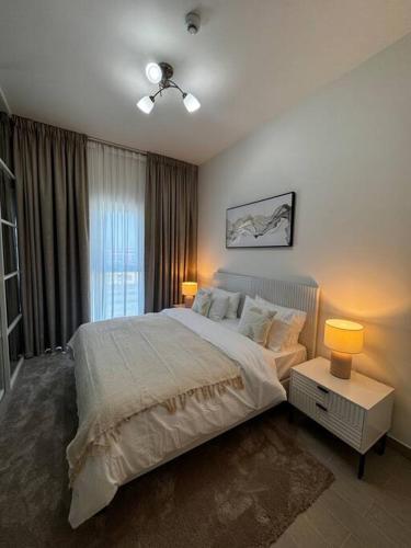 a bedroom with a large bed and a window at Golfville LighthouseDubai Hills in Dubai
