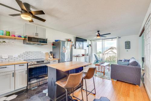 a kitchen with a table and chairs in it at Kailua-Kona Condo with Balcony Walk to the Beach! in Kailua-Kona