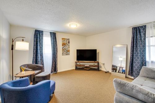 a living room with blue chairs and a television at Cozy Clearfield Apartment - 3 Mi to Downtown! in Clearfield