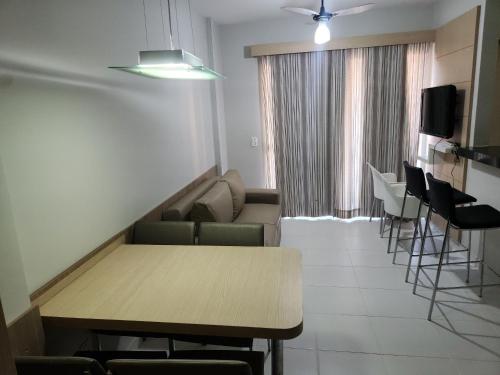 a waiting room with a table and chairs and a tv at Apartamentos em Rio Quente com maravilhosa área de lazer e excelente localização in Rio Quente