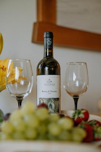 a bottle of wine sitting next to two wine glasses at "Podhalański Gościniec" -250 m Gorący Potok ,Termy Szaflary in Szaflary
