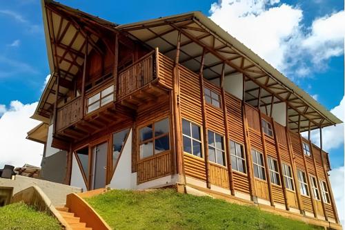 a large wooden house on top of a hill at Club Cean in Madroñal