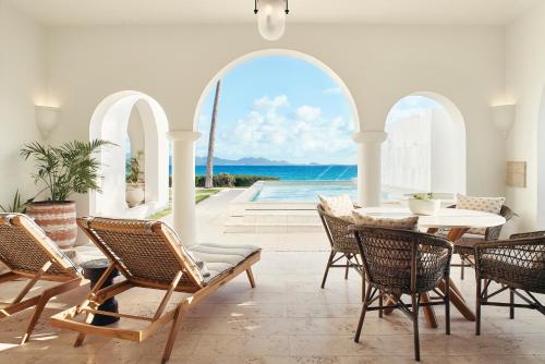 West End VillageにあるCap Juluca, A Belmond Hotel, Anguillaの海の景色を望むパティオ(テーブル、椅子付)