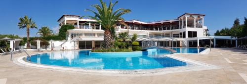 a large swimming pool in front of a building at Alexandros Palace in Ouranoupoli