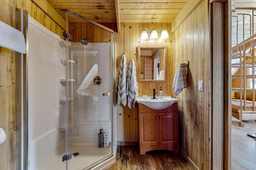 a bathroom with a shower and a sink at On Timbered Time in Munds Park