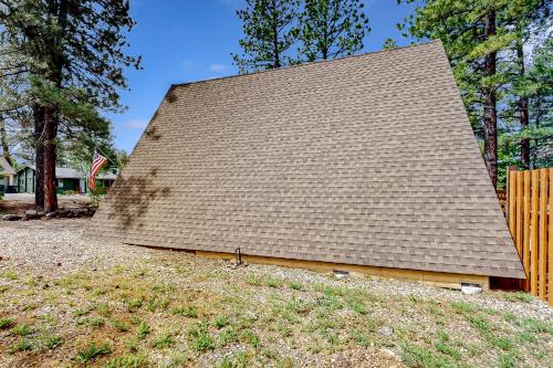 a house with a roof on top of a yard at On Timbered Time in Munds Park