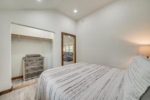 a bedroom with a bed and a dresser and a mirror at Secluded Broken Bow Cabin with Fishing Pond and Views! in Broken Bow
