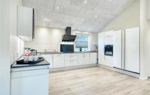 a kitchen with white cabinets and a white refrigerator at Beautiful Home In Varde With Kitchen in Varde