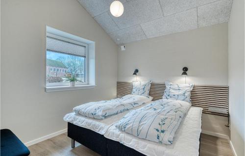 two beds in a room with a window at Beautiful Home In Varde With Kitchen in Varde