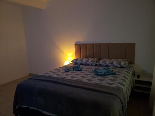 a bedroom with a bed with two bags on it at Pousada Monte Gerizim in Sao Paulo
