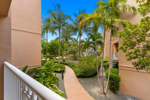 a balcony of a building with palm trees at Beachside Resort & Residences in Key West
