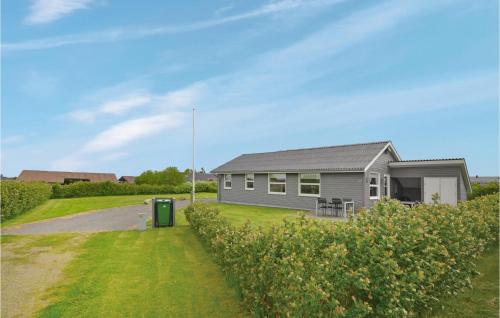 a house with a green trash can in front of it at Holiday Home Strandlyst Vinderup Vi in Vinderup