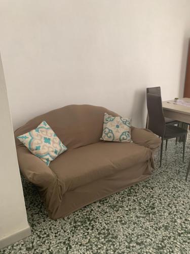 a brown couch sitting in a living room with a table at Nonna Annunziata in Gemini
