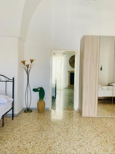 a room with a mirror and a vase on the floor at Nonna Annunziata in Gemini