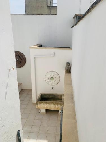 a room with a fireplace in a white wall at Nonna Annunziata in Gemini