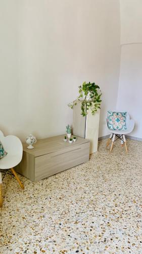 a living room with a coffee table and a chair at Nonna Annunziata in Gemini