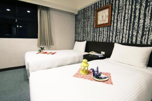 Un ou plusieurs lits dans un hébergement de l'établissement LIHO Hotel Tainan