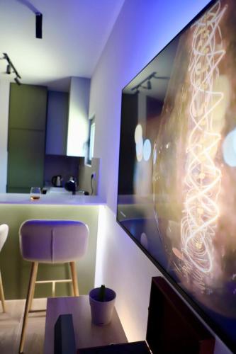 a living room with a large tv and a purple chair at Adriatic Dream in Tivat