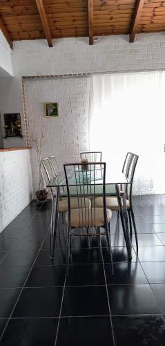 a dining room with a table and four chairs at Polyxeni Apartments & Rooms in Qeparo