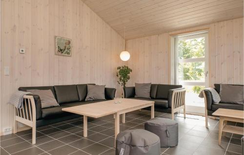 a living room with a couch and a table at Four-Bedroom Holiday Home In Lokken in Løkken