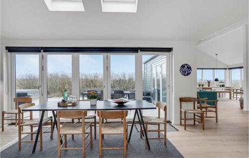 a dining room with a table and chairs at Five-Bedroom Holiday Home Løkken With A Room Hot Tub 04 in Løkken