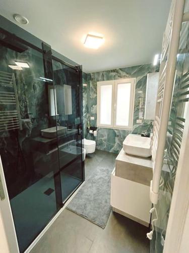 a bathroom with a shower and a sink and a toilet at DolceVita apartment in Como