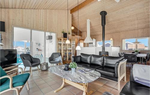 a living room with a couch and a table at Stunning Home In Thisted With Sauna in Klitmøller