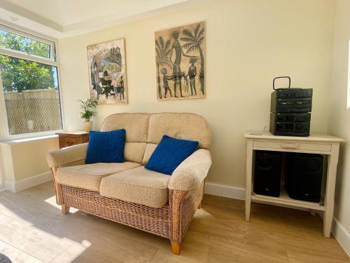 a living room with a chair and a television at 3-bed cottage in Sway, New Forest (5 min walk from Sway Train Station) in Sway