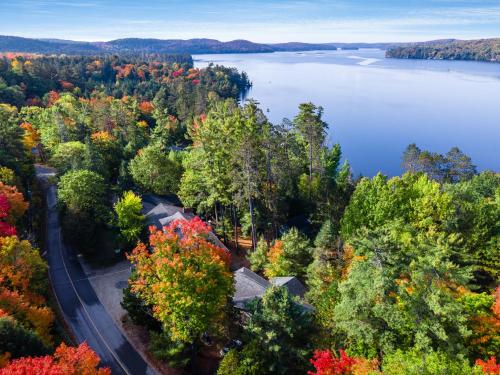 an aerial view of a house on the shore of a lake at Muskoka Waterfront Retreat in Dwight