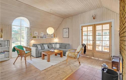 a living room with a couch and a table and chairs at Holiday Home Rylen Rømø Xi in Rømø Kirkeby