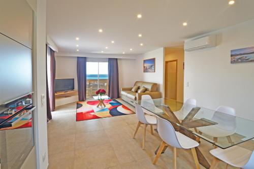 a living room with a glass table and chairs at Résidence Saint-Jean in Saint-Florent