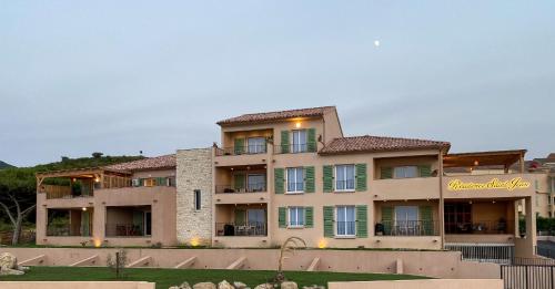 a large apartment building with a sign on it at Résidence Saint-Jean in Saint-Florent