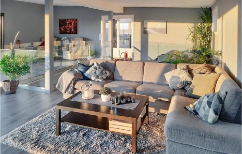a living room with a couch and a coffee table at Nice Home In Sandefjord With Wifi in Sandefjord
