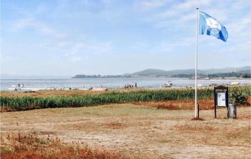 a blue and white flag on the beach at 3 Bedroom Awesome Home In Ebeltoft in Ebeltoft