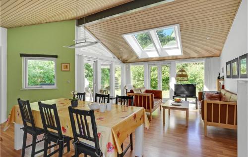 a dining room and living room with a table and chairs at 3 Bedroom Awesome Home In Ebeltoft in Ebeltoft