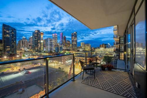a balcony with a view of a city skyline at "The Draper" - Luxury Corner Unit w Tower View, - Near Stampede, Saddledome, BMO Centre! FREE Parking, Banff Pass, & Wine! in Calgary