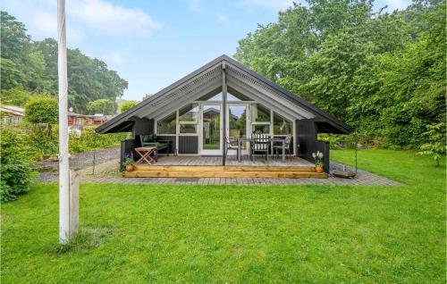 a tiny house with a pitched roof and a deck at Amazing Home In Haderslev With Wifi in Haderslev