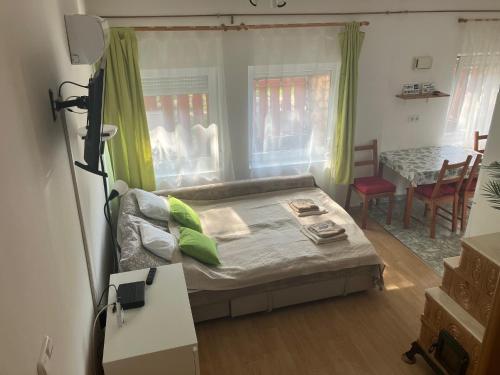 a small living room with a couch and a table at Tőserdei Vendégház in Lakitelek