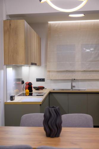 a kitchen with a table with chairs and a counter top at Next Vision Residence in Anatolí